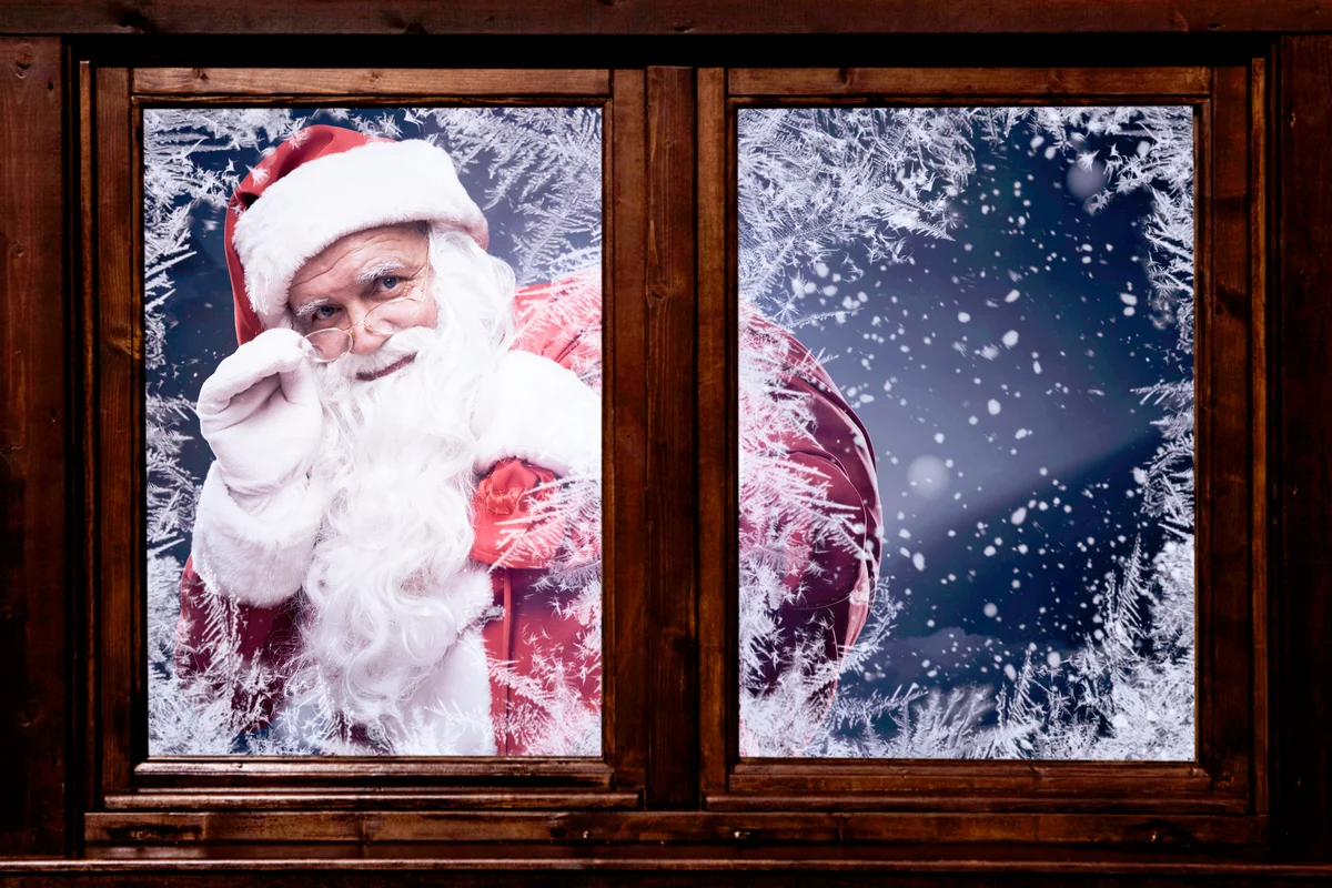 Traditional Santa Claus looking through the window