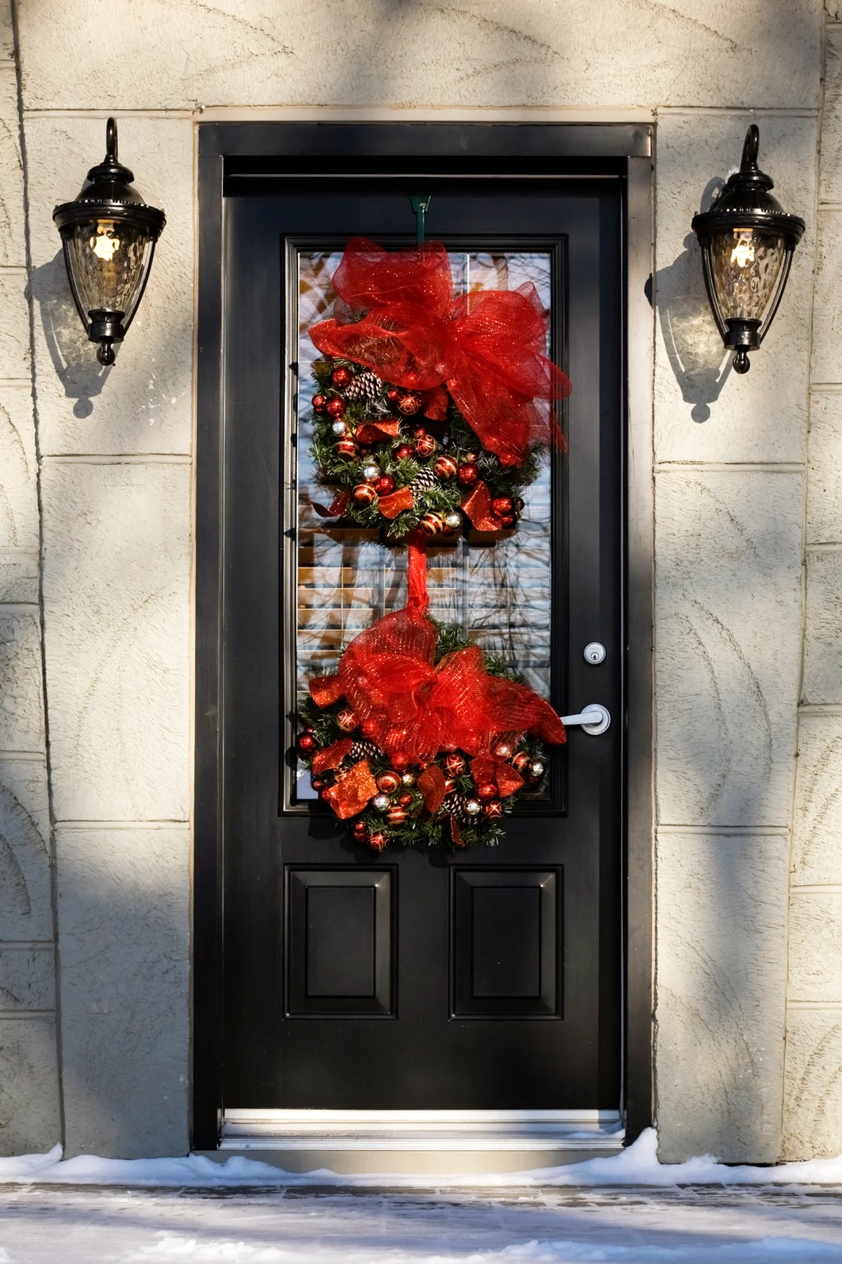 Front Entrance Door On A Residential Home With Christmas Decorations In Winter