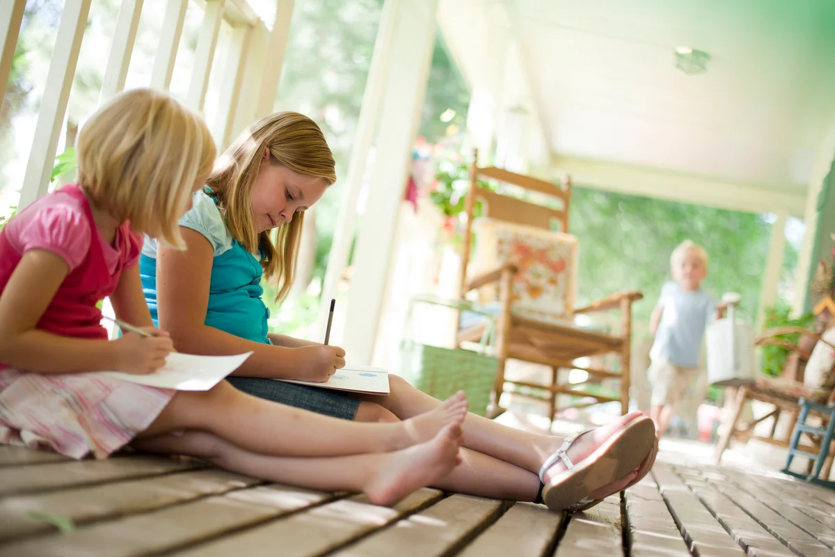 Two girls writing letters