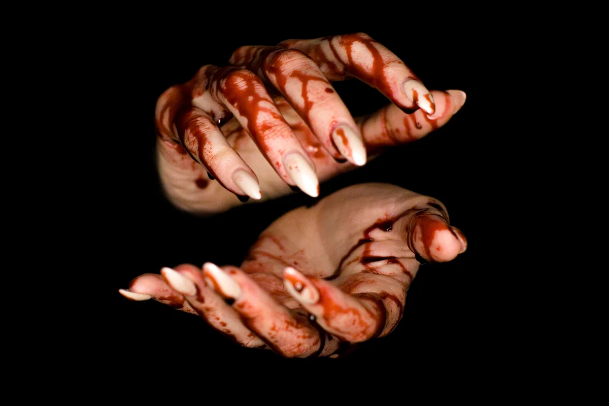 Bloody hand on dark background