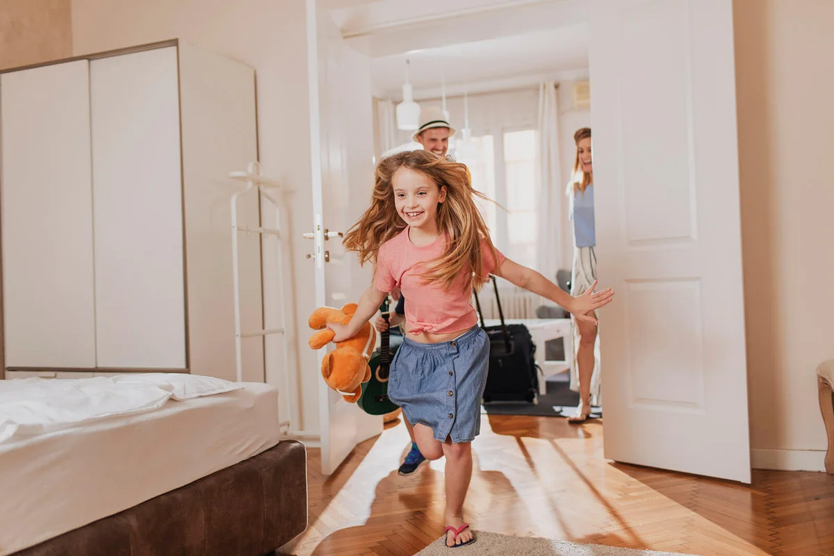 happy family entering their accomodation