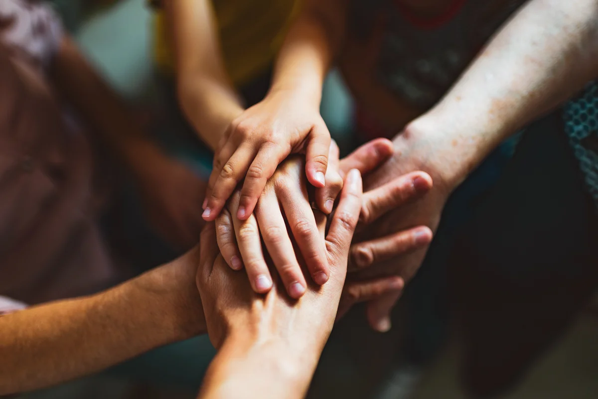 Multi-generation family holding hands