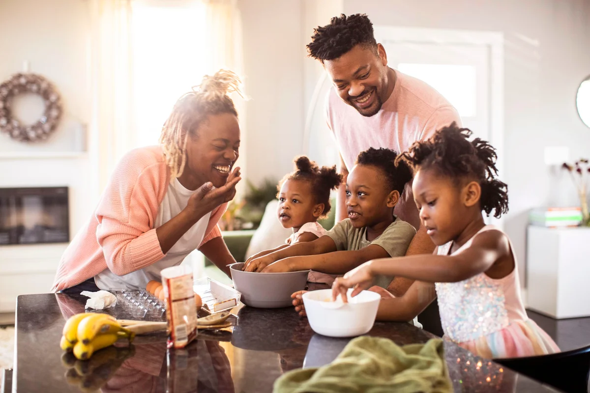 Family mixing cookie dough at home