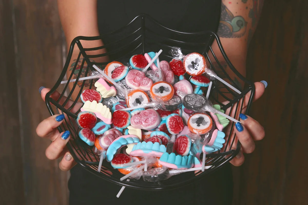 Woman offering Halloween candies