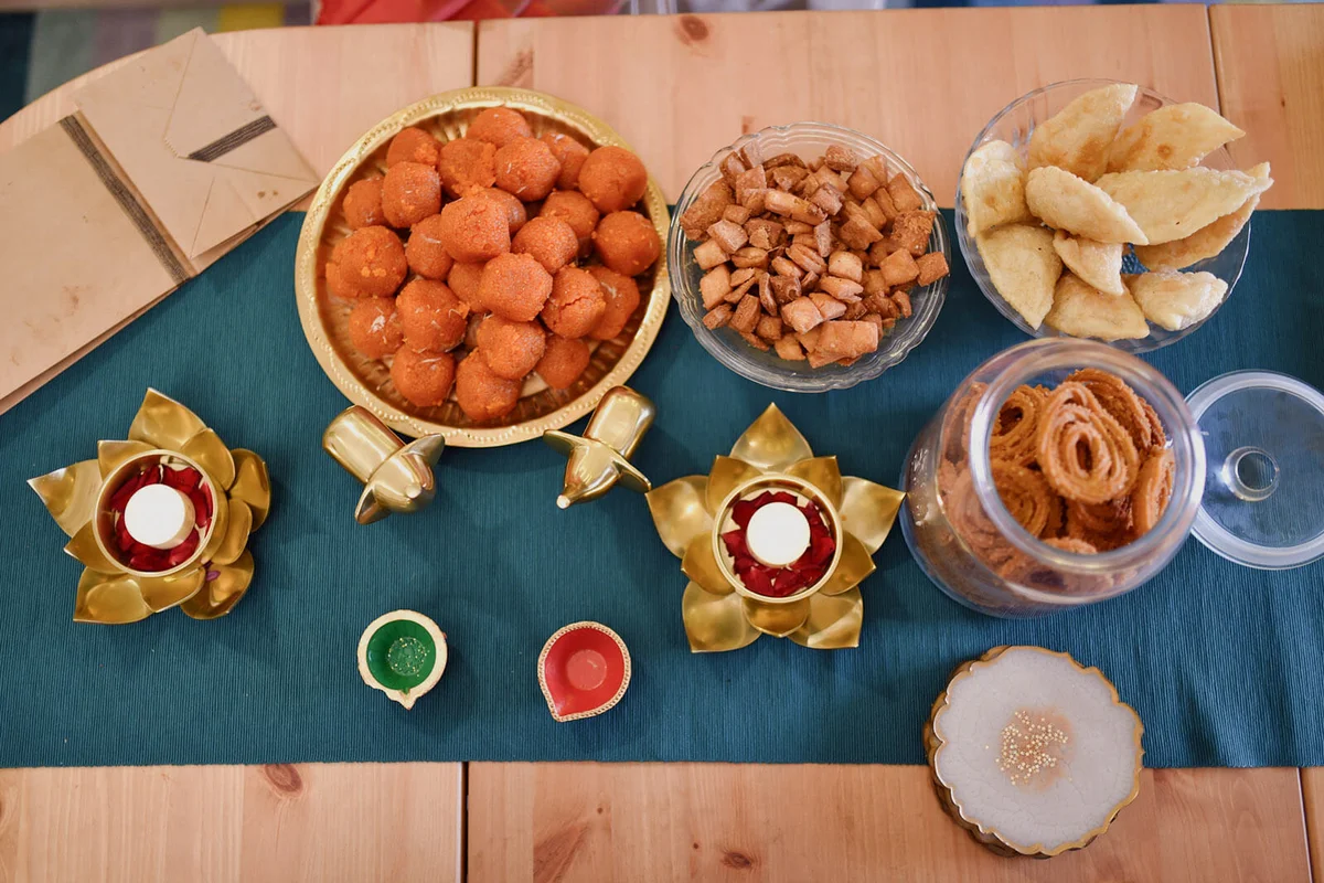 Arrangement of Lamps and Indian snacks during Diwali celebration