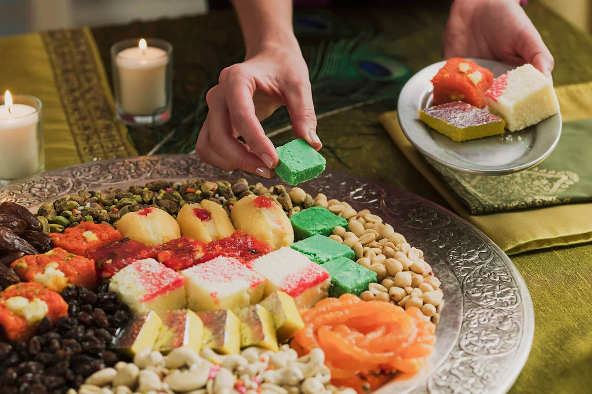 Person with platter of Diwali sweets