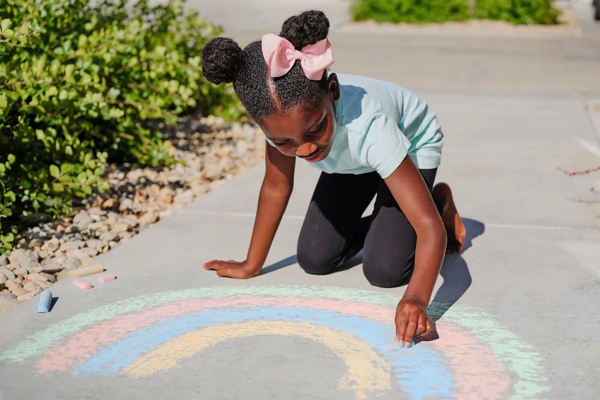 Little Girl Drawing with Sidewalk Chalk