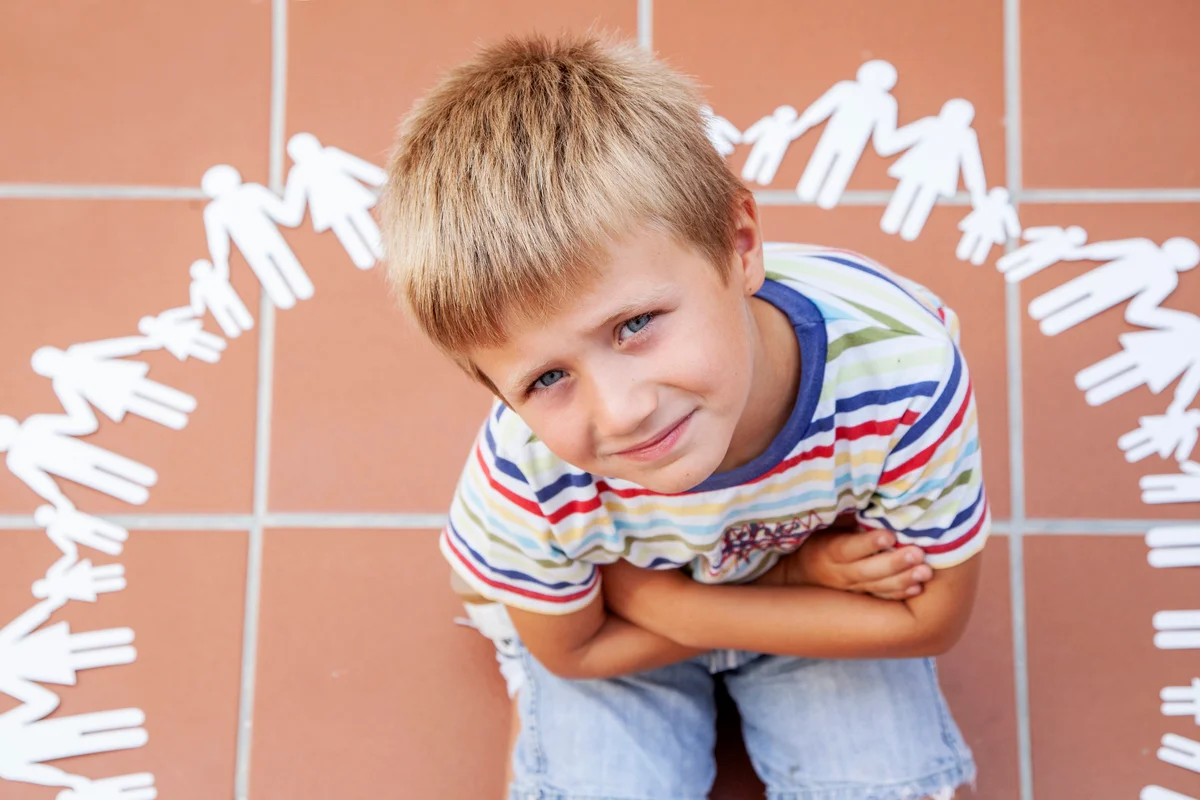 Child inside a circle of cutouts