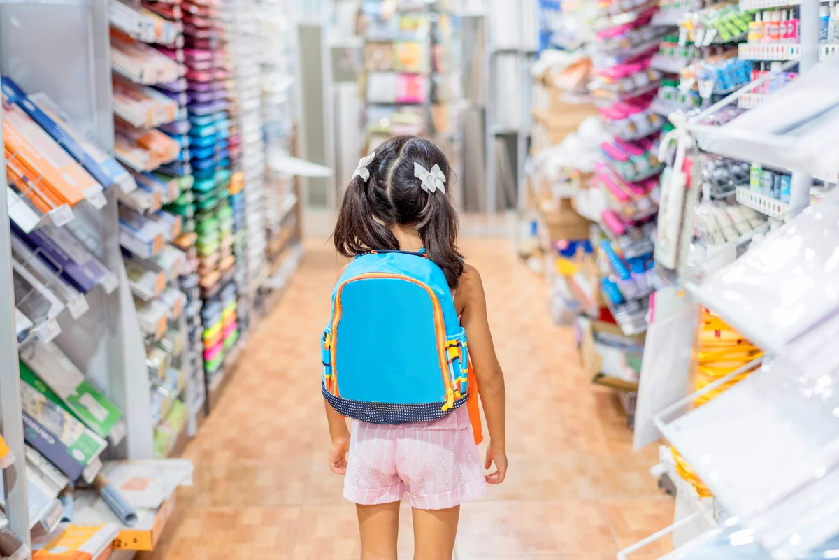 Girl With Backpack Standing In Store