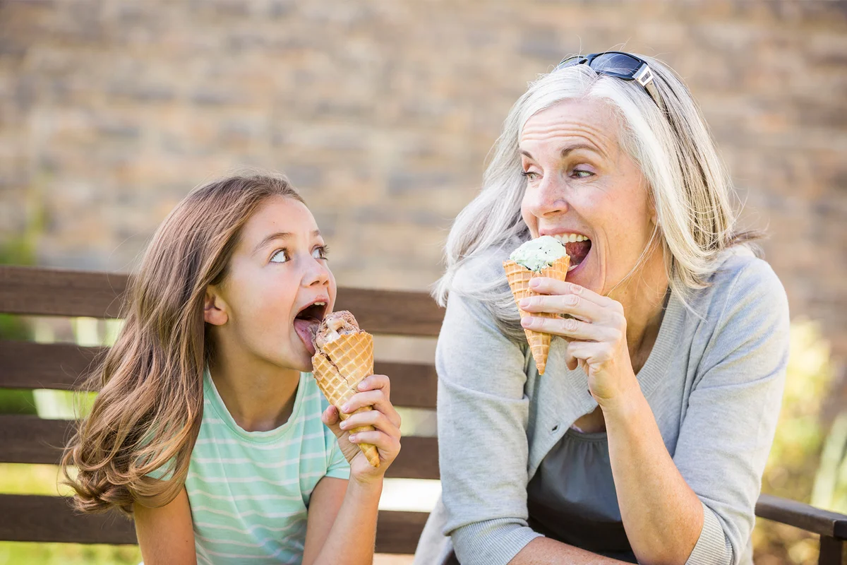 Grandmother and granddaughter eating ice cream