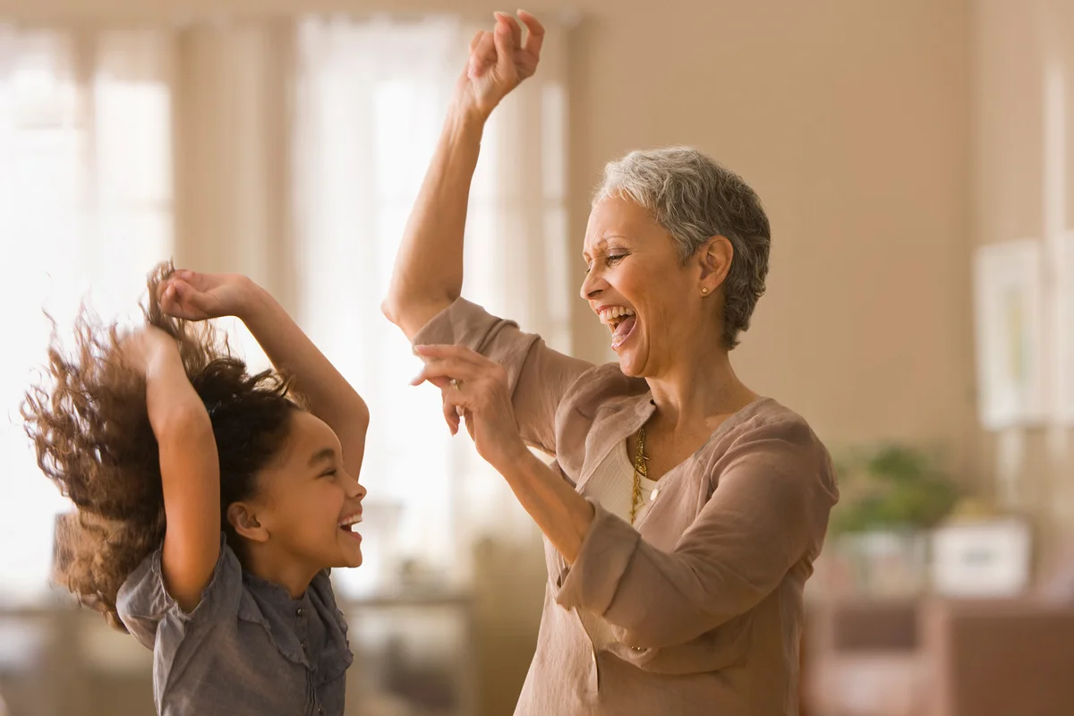 Grandmother and granddaughter dancing
