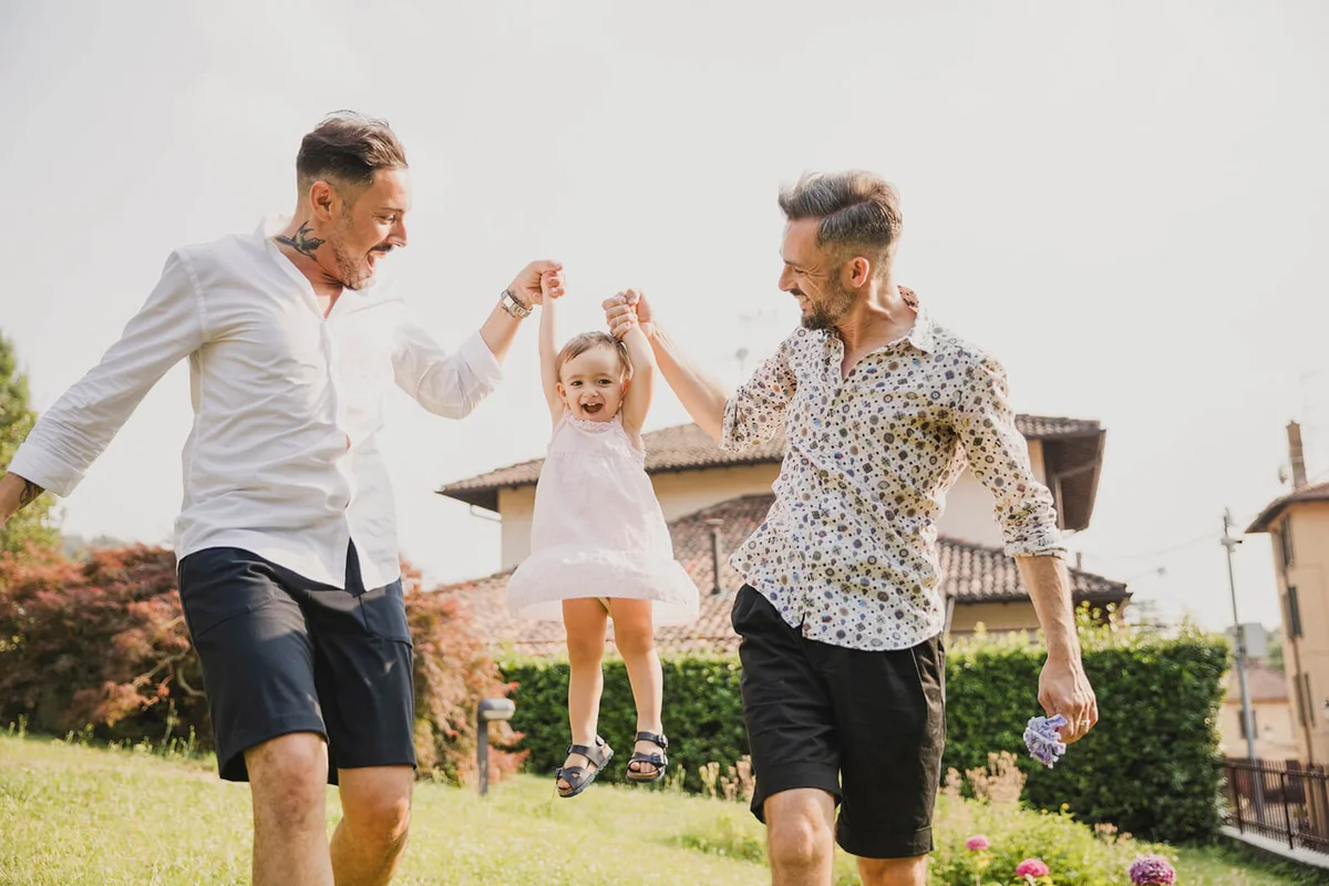 Happy couple playing with their child in the garden