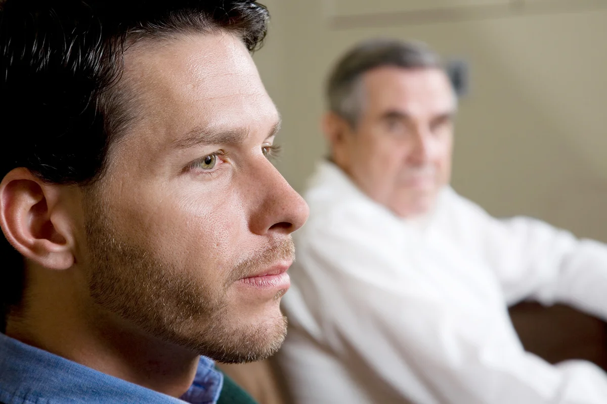 Closeup of man with father looking on