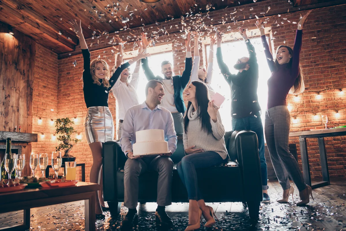 Friends throwing confetti at baby shower
