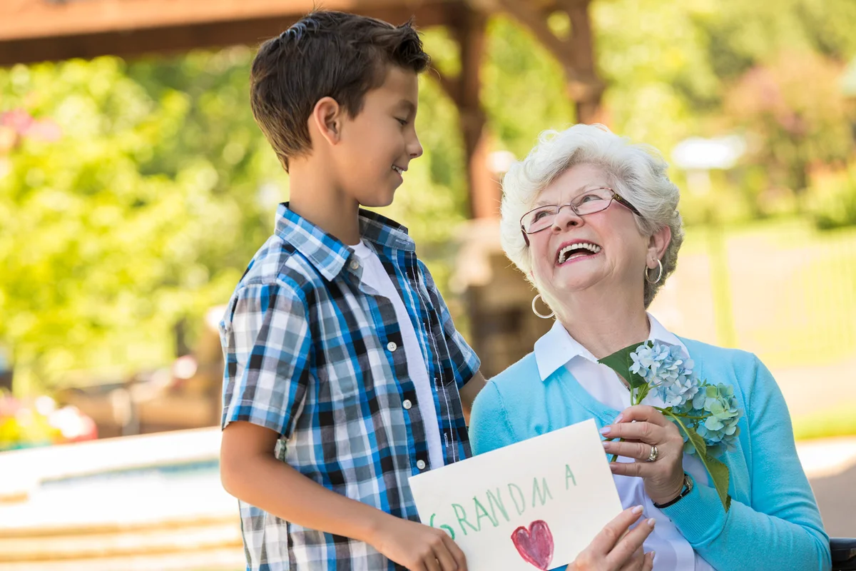Grandmother looks up at her grandson