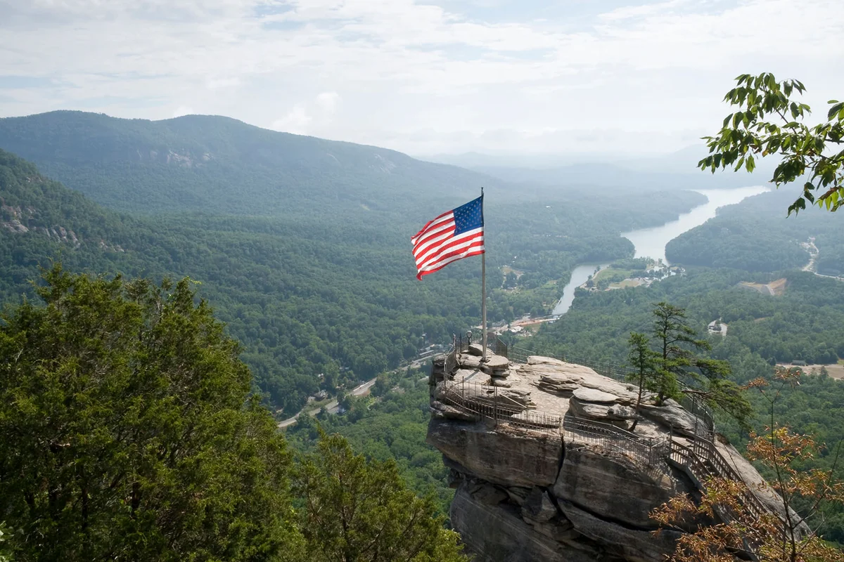 Top of Chimney Rock, North Carolina, with a waving American flag
