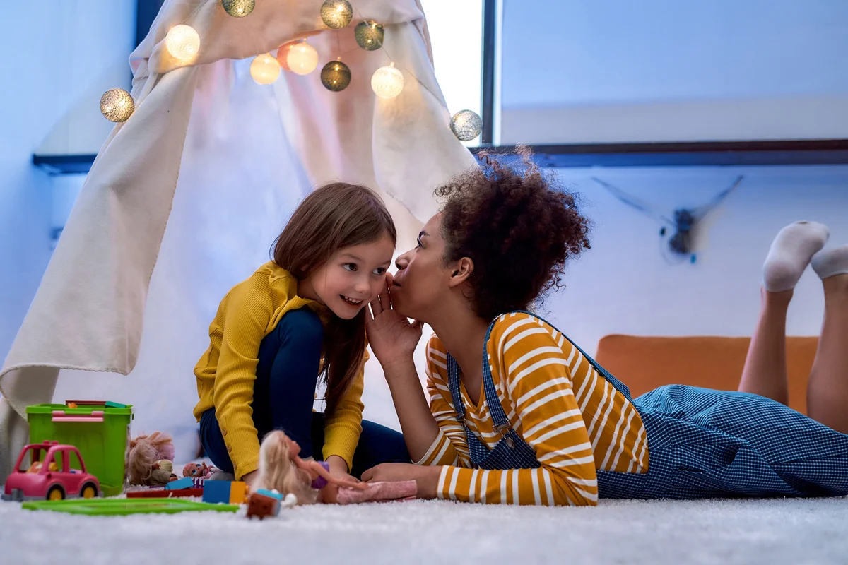Baby sitter entertaining cute little girl