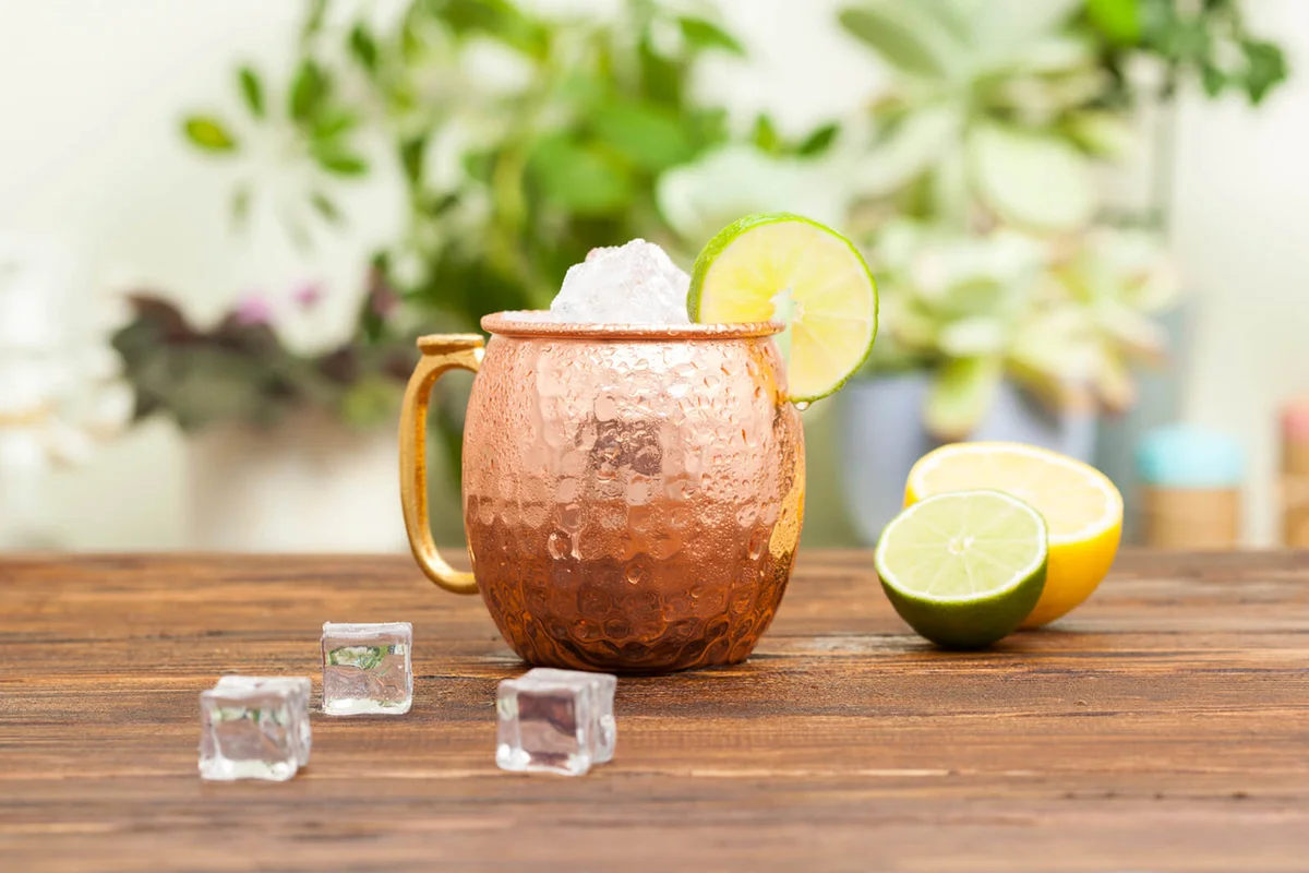 Mug with ice and lime on the table