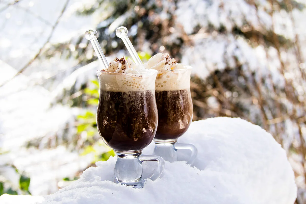 Two glasses Pharisee with coffee, rum and cream, in snow