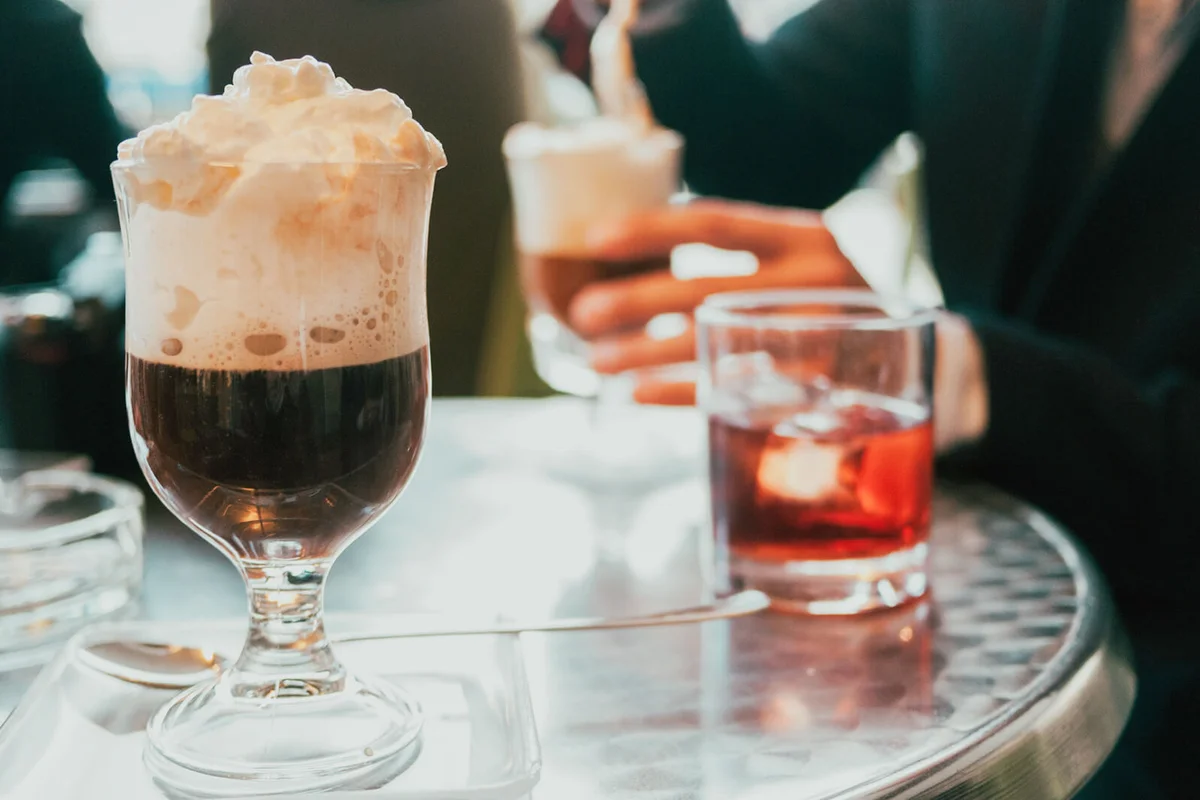 Irish coffee and vermouth in the background