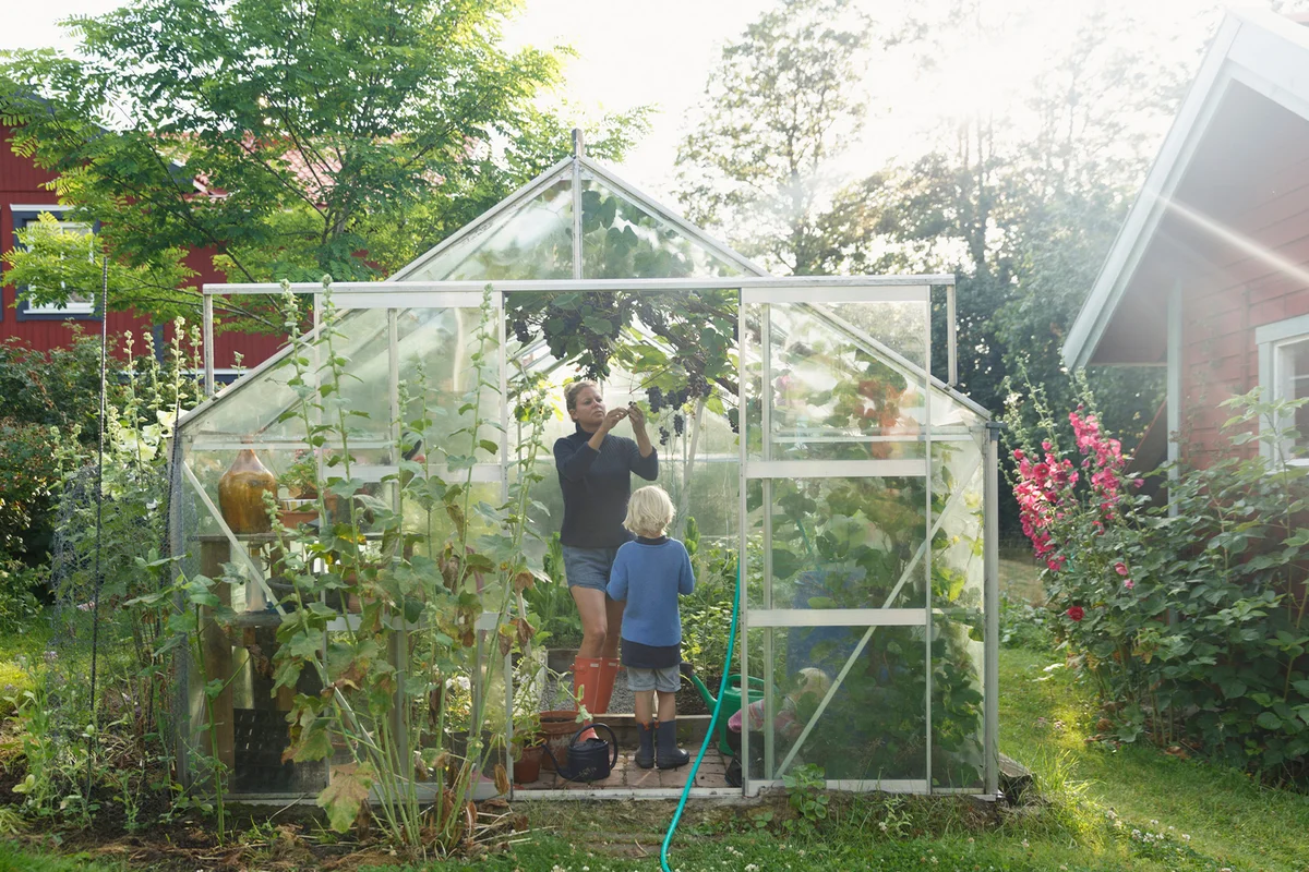 Mother with son in greenhouse