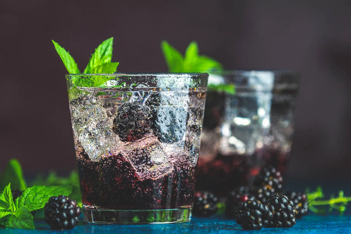 Close up of cold summer berry drink with blackberries