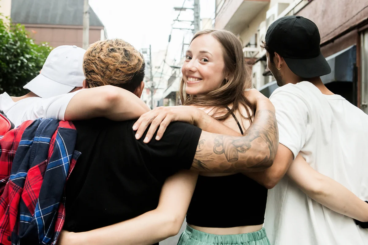 A woman hugging her friends