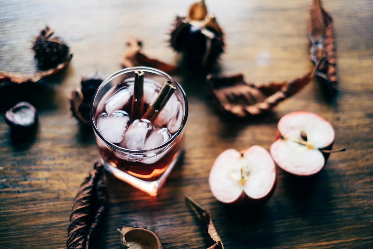 apple cider cocktail with cinnamon sticks