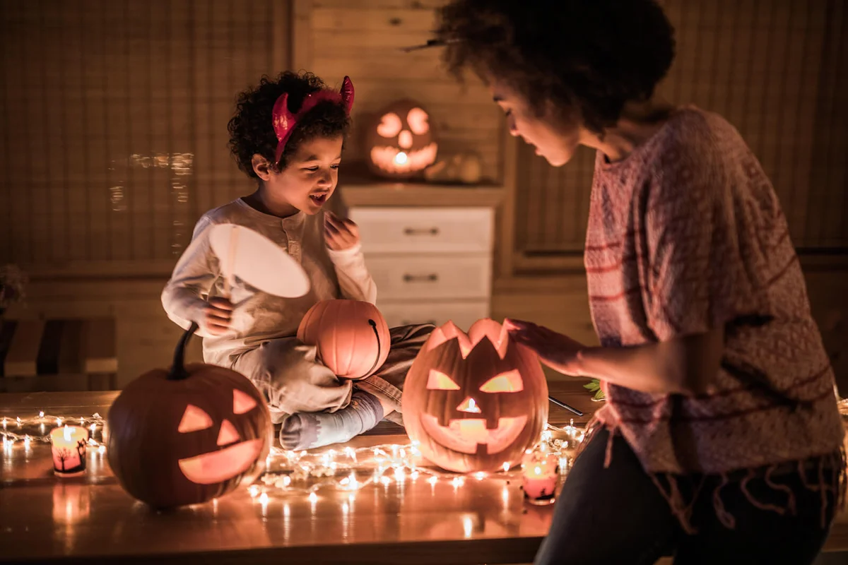 mother and her son preparing for Halloween party at home