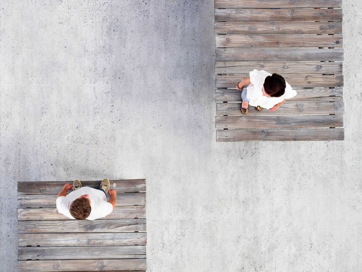 Couple standing on opposite wooden docks