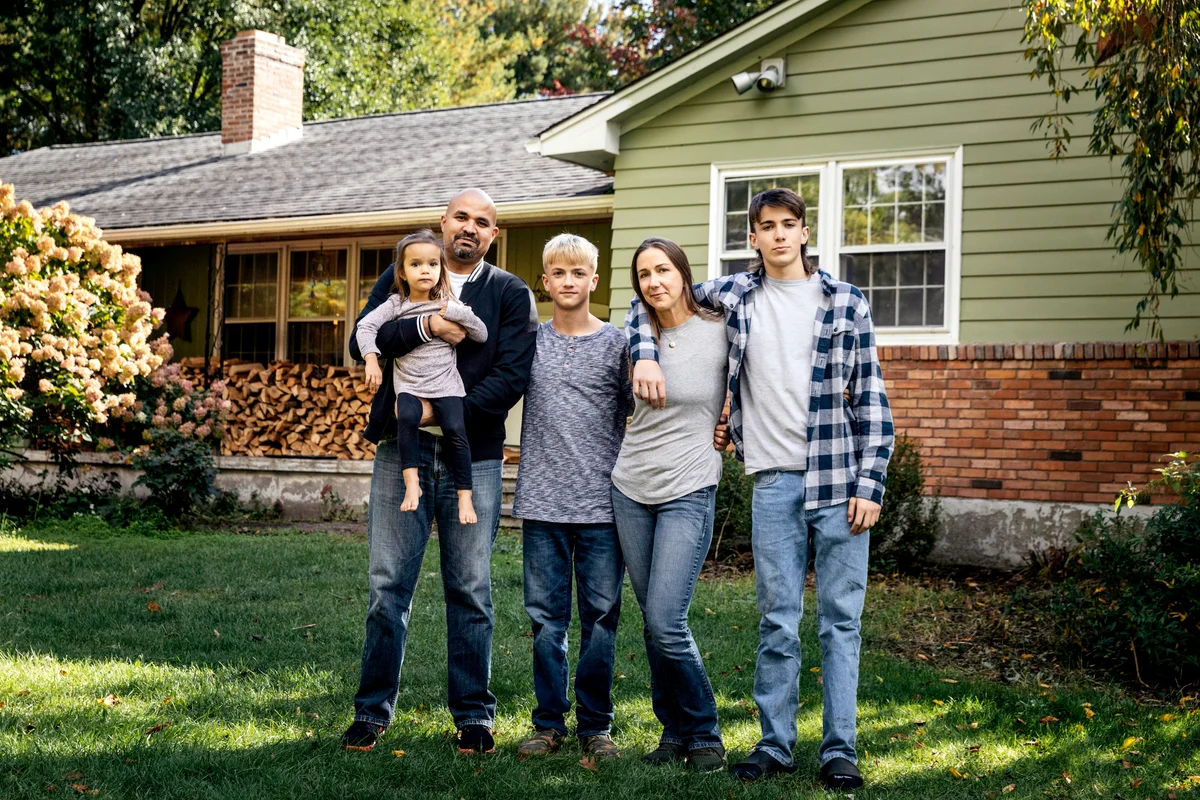 Blended family standing in front yard at home
