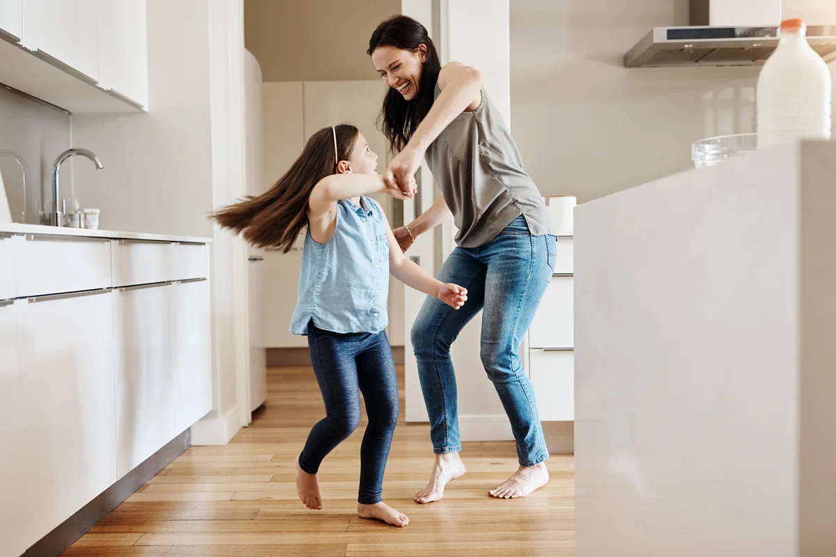 little girl dancing with her mother