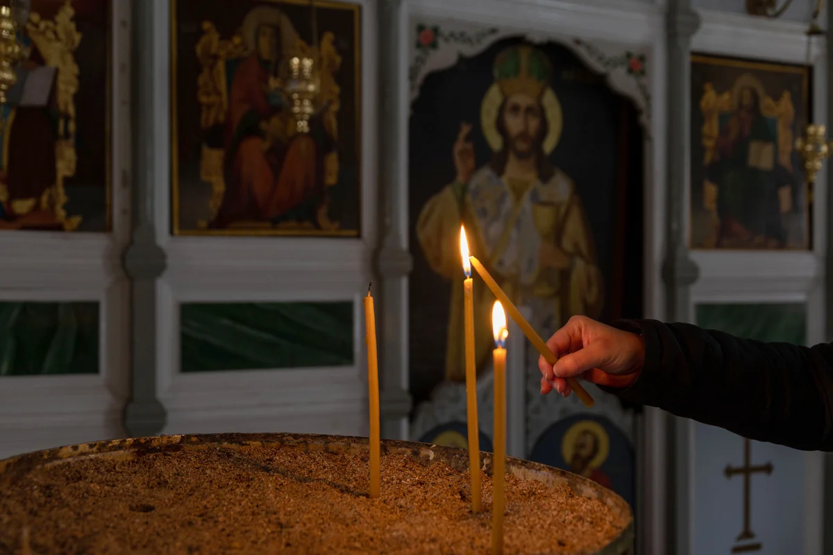 Lighting a candle inside a Greek Orthodox church