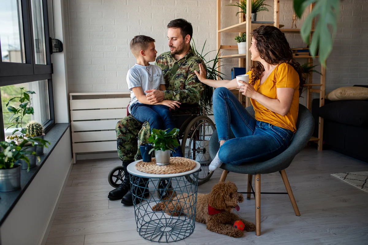 Male Veteran In Wheelchair with his family
