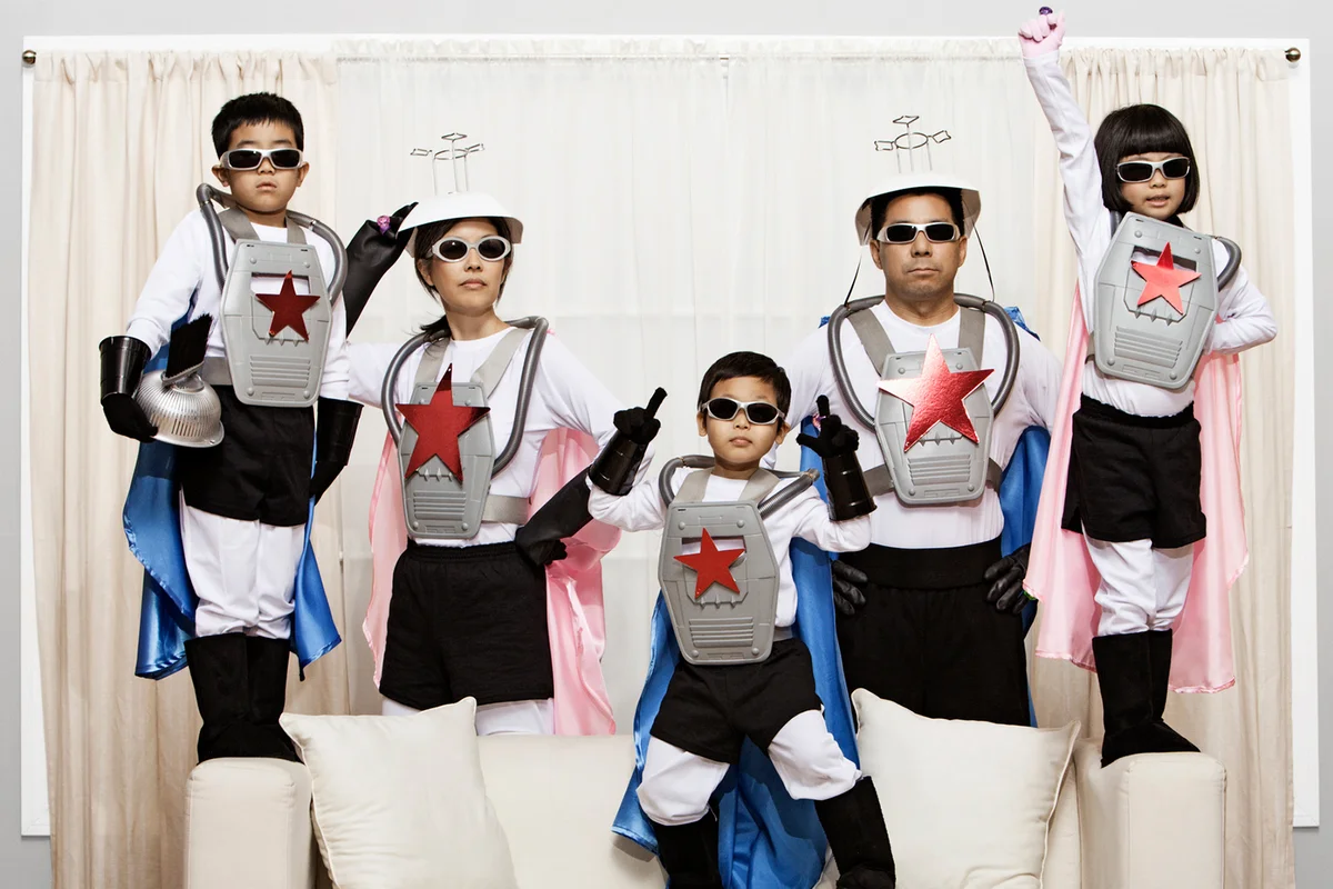 Asian family in superhero costumes