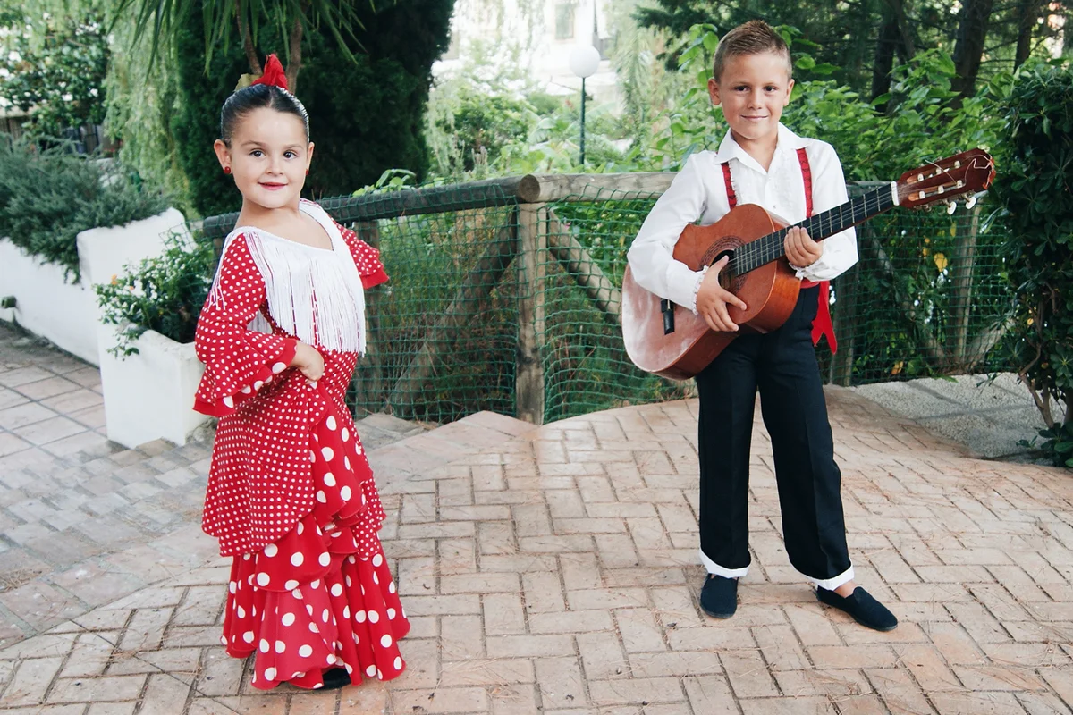 Girl and boy in traditional flamenco costumes
