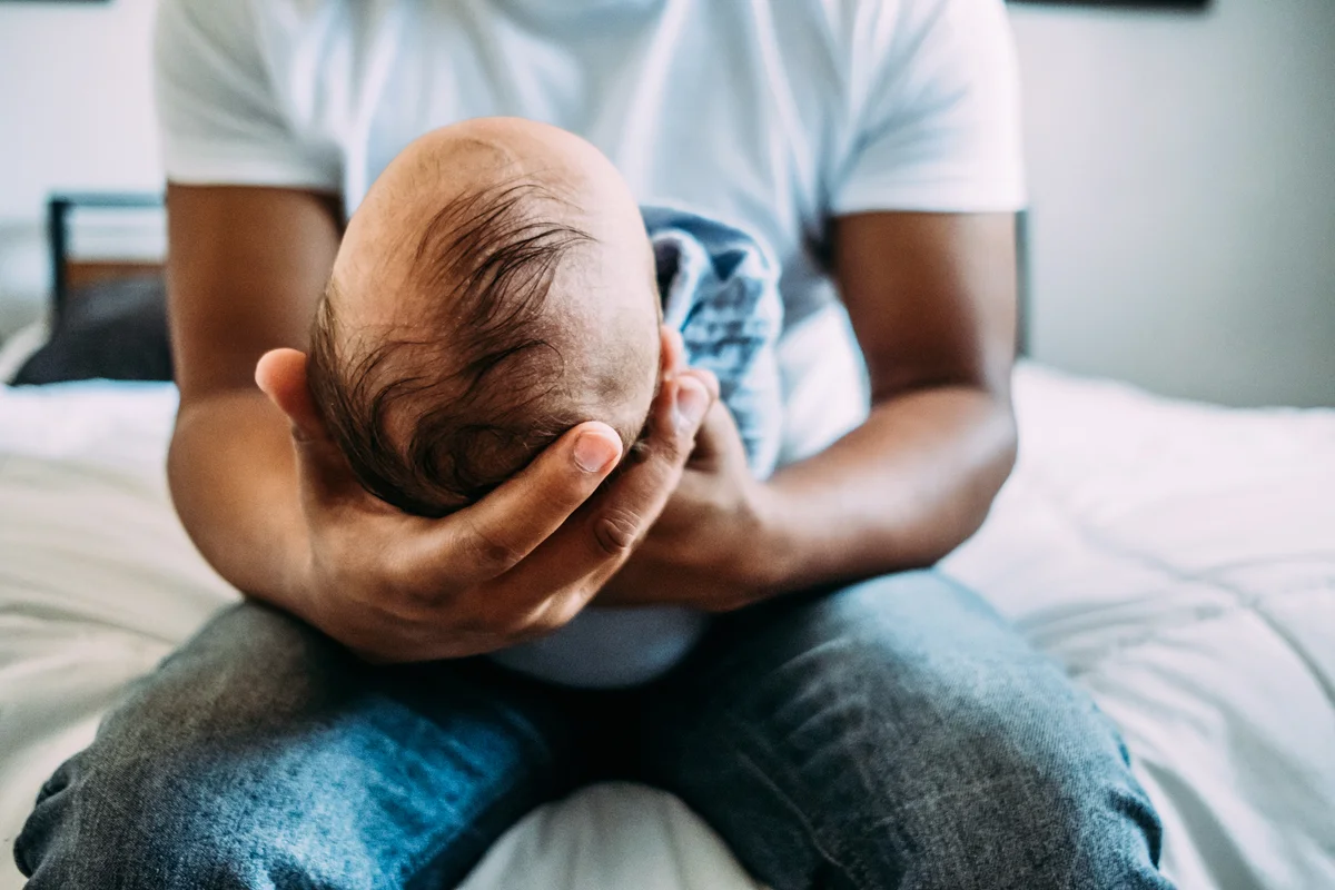 Dad holding newborn baby