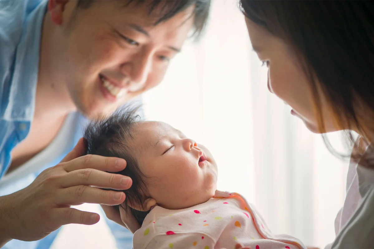 Japanese mother and father with newborn daughter