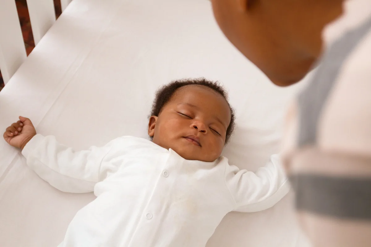 African Baby sleeping in crib