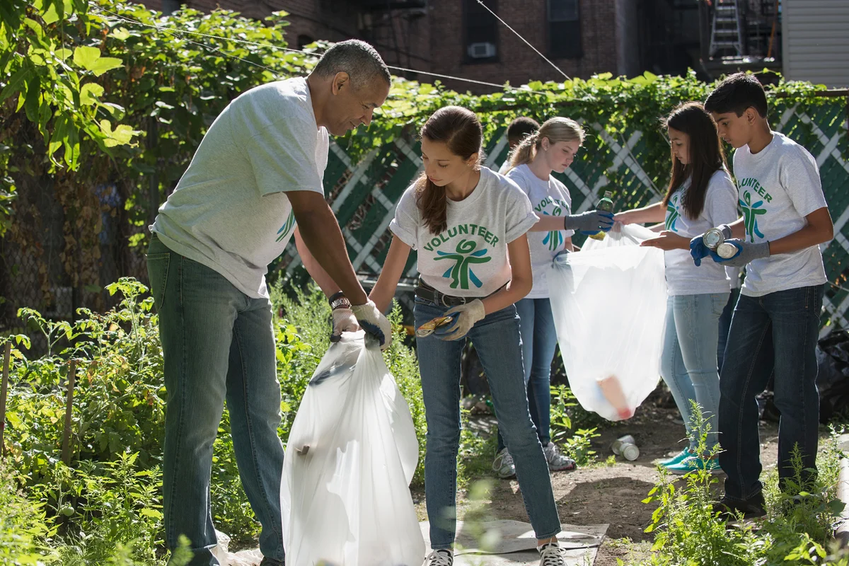 Volunteers picking up litter in urban garden