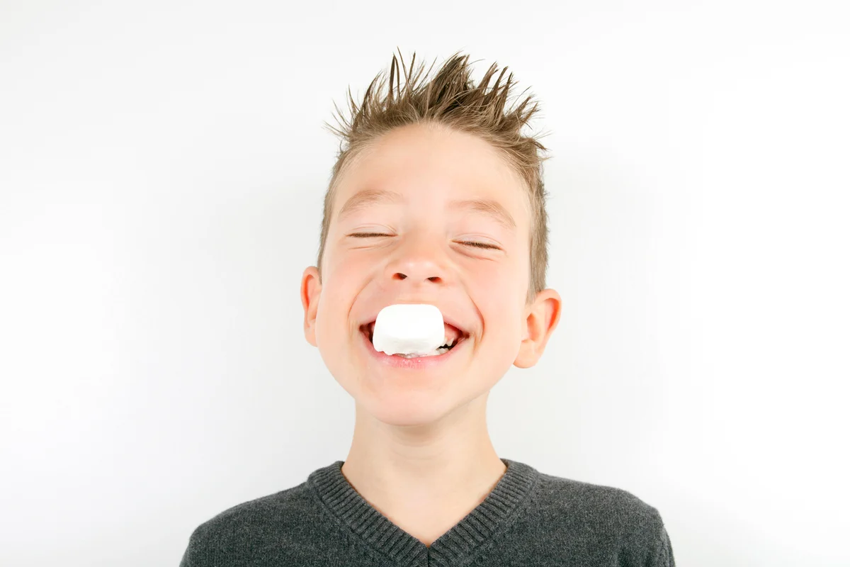 Boy eating marshmallow