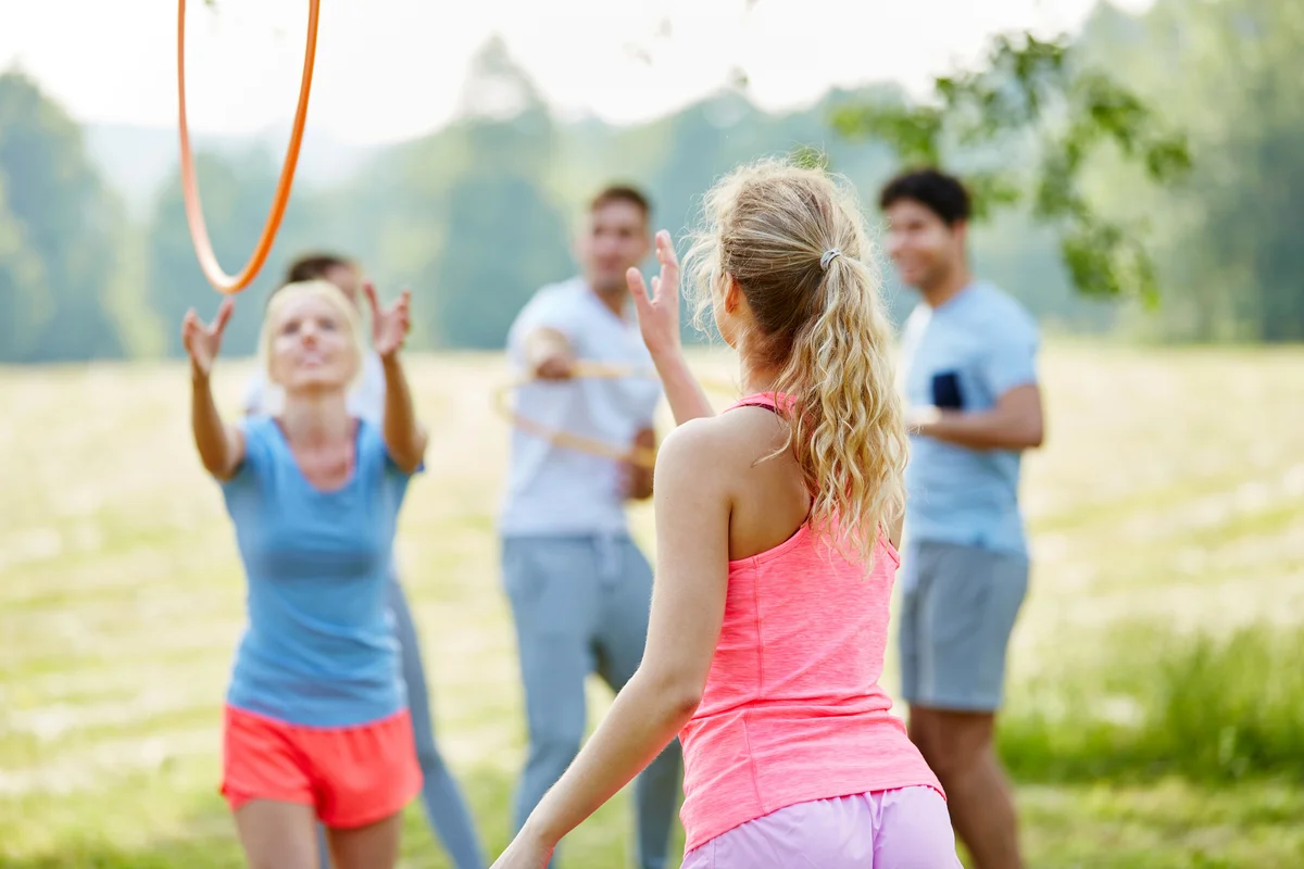 Family tossing hula-hoops