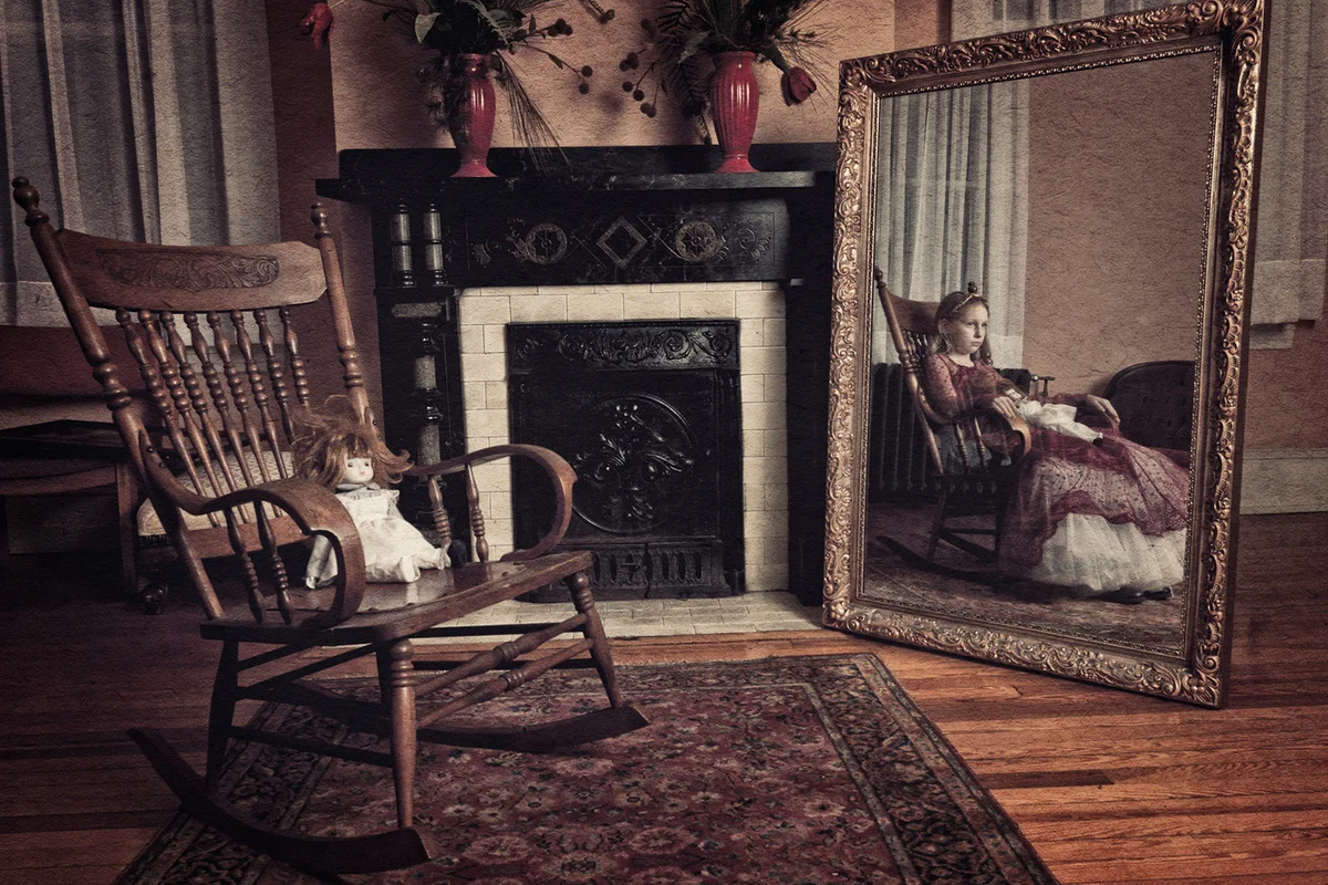 Ghost of little girl sitting in the rocker chair