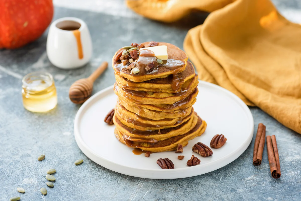 Pumpkin spice pancakes with caramel sauce and butter