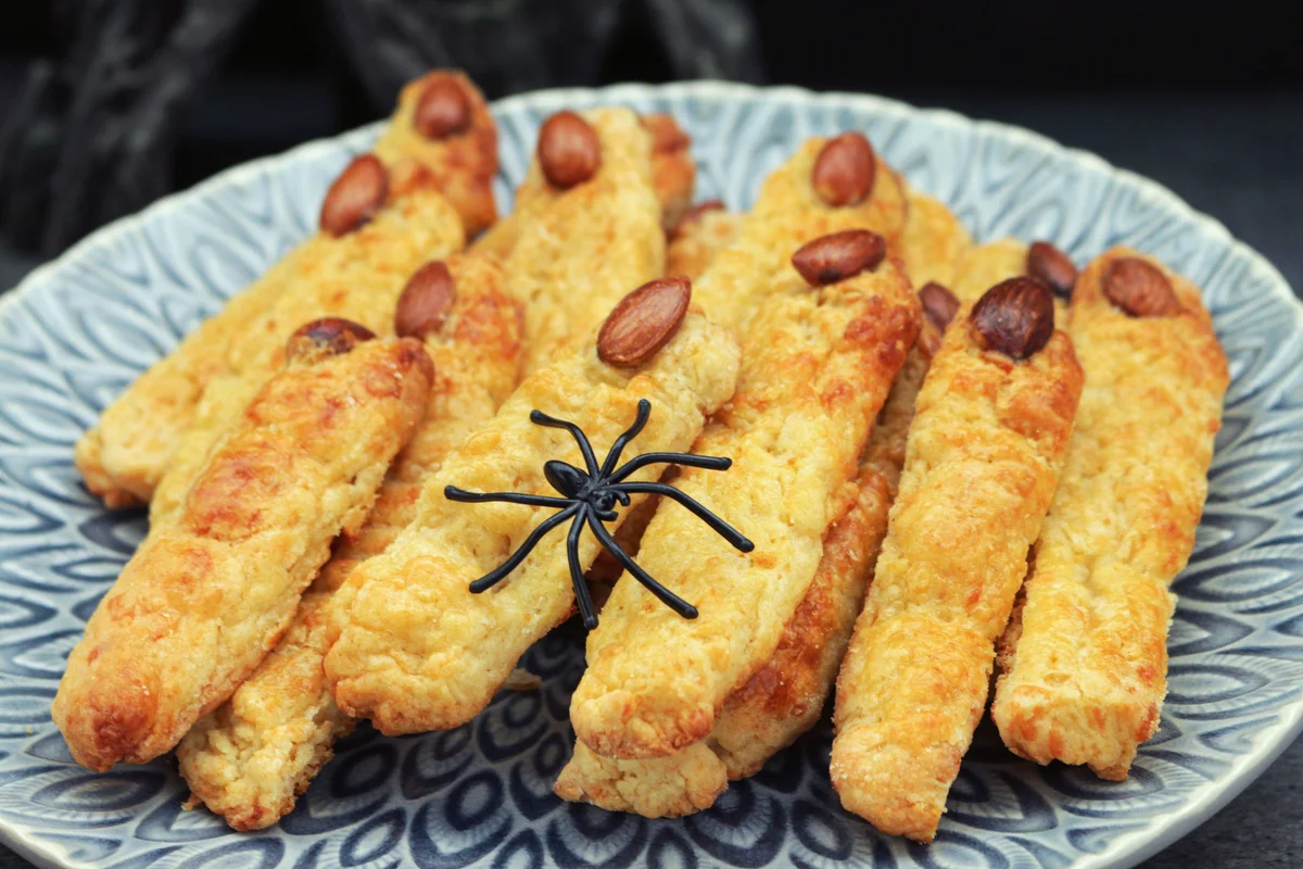 Cheese straws shaped like fingers with almond fingernails