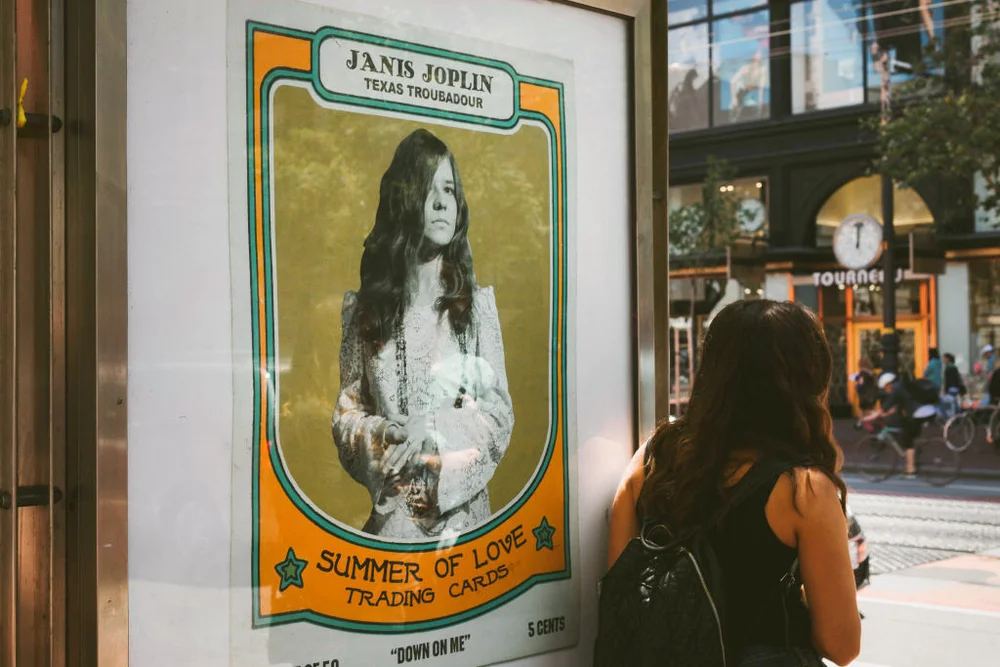 Old poster with Janis Joplin in a street of San Francisco