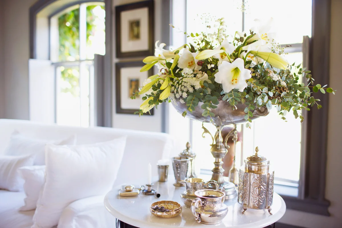 Bouquet and antique silver on living room table