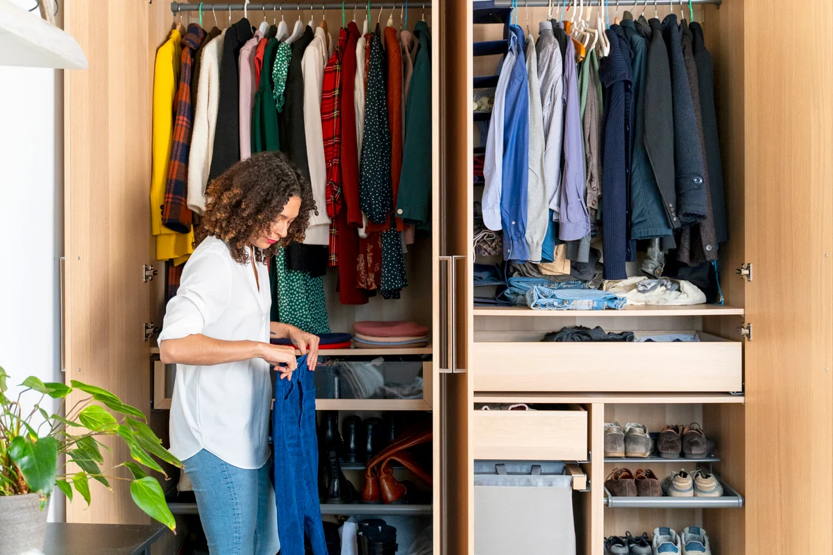 Woman clearing out her wardrobe