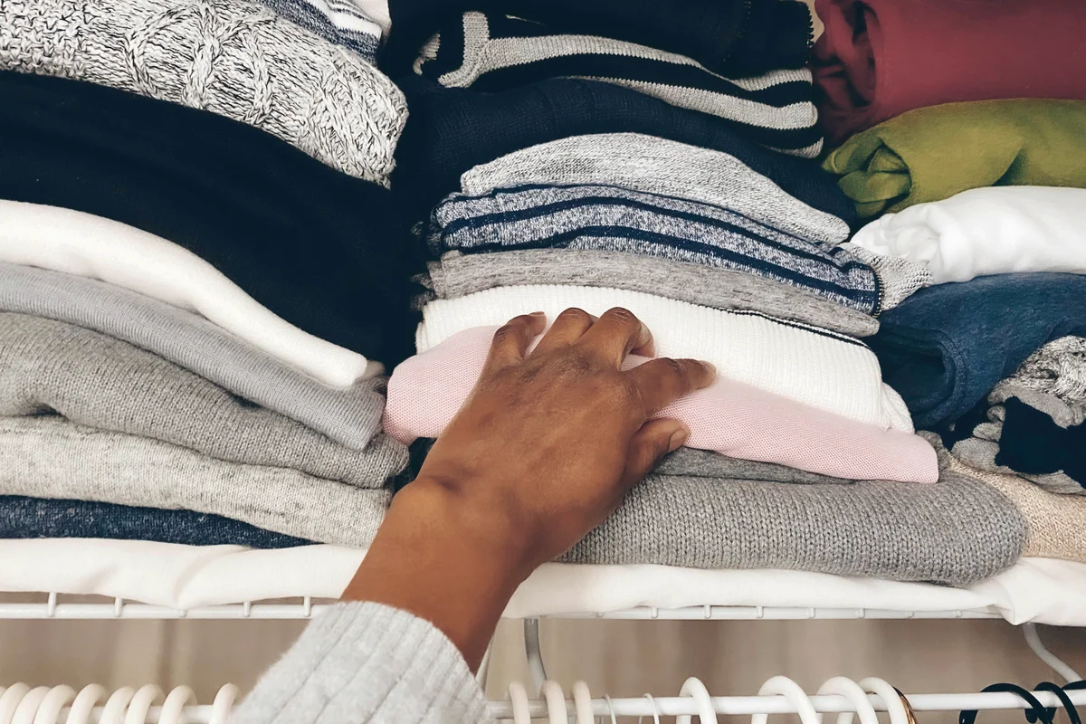 Woman Reaches on Top Shelf in Closet