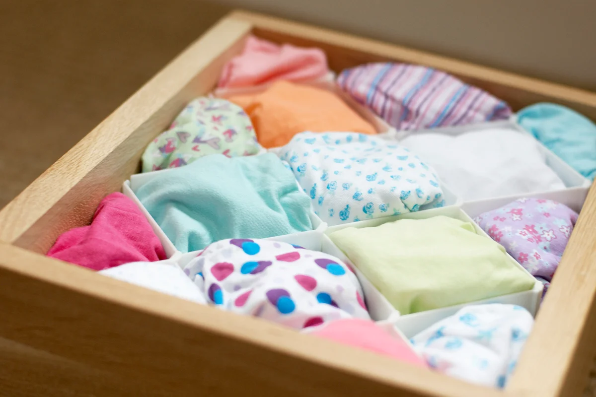 Drawer containing folded underwear, separated by dividers